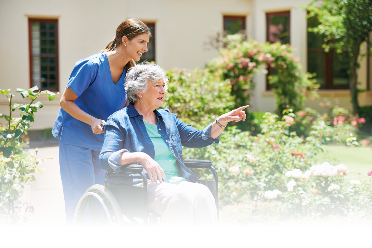 Shot of a resident and a nurse outside in the retirement home garden