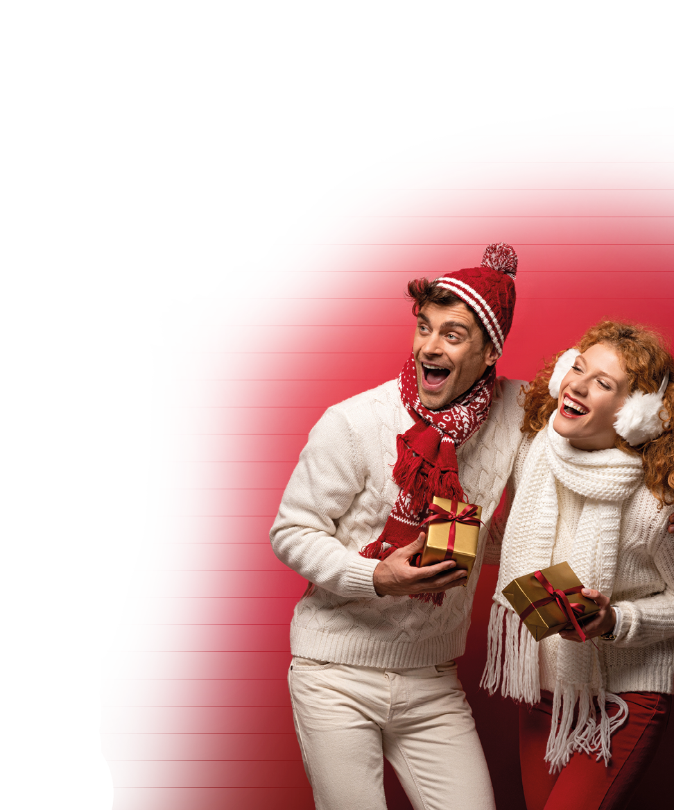 beautiful happy couple in winter outfit holding christmas gifts isolated on red