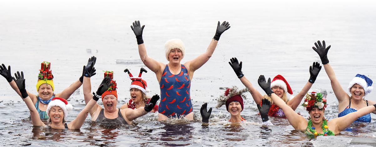 Loch Insh Festive ice swim. Members of the Loch Insh Dippers wild swim group take part in a Christmas-themed swim in the frozen Loch Insh, Kingussie, in the Cairngorms National Park. Picture date: Friday December 13, 2024. Photo credit should read: Jane Barlow/PA Wire URN:78474364