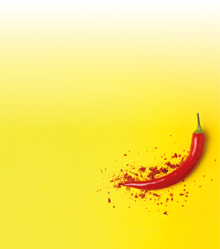 Tasty chilli pepper and powder spice on yellow background